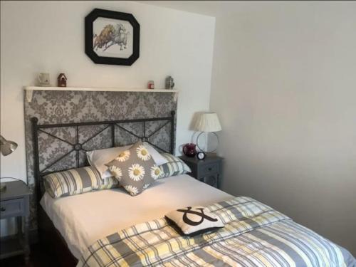 a bedroom with a bed with two pillows on it at Middle Tree, ideal modern cottage in Alburgh