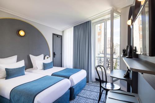 a hotel room with two beds and a desk and a window at H&ocirc;tel de France Gare de Lyon Bastille in Paris