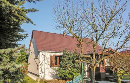 a small white house with a red roof at Lovely Home In Wronki With Sauna in Chojno