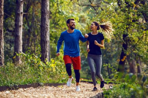 a man and a woman running in the woods at NP Hotel Wittenbeck in Kühlungsborn