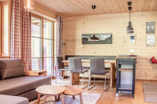 a living room with a couch and a table at Alpin Chalet Schröcken in Schröcken