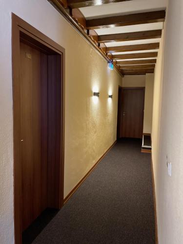 a hallway of an office building with a door and a hallwayngth at Hotel Residenz in Ansbach