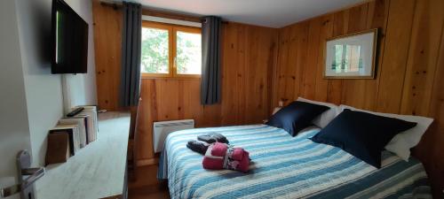 a bedroom with a bed with two backpacks on it at Entre dune et plage Les Jacquets Cap Ferret in Lège-Cap-Ferret