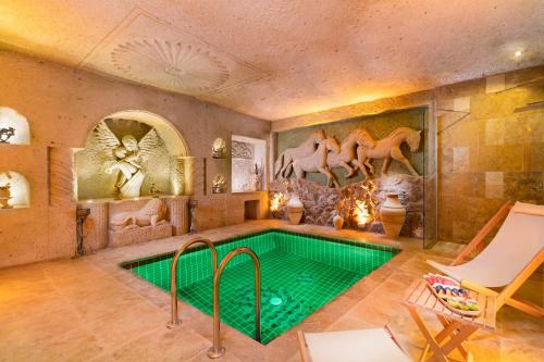 a home with a pool in the middle of a room at Oba Cave Hotel in Urgup