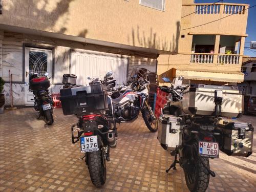 a group of motorcycles parked in front of a building at Hôtel Imilchil in Midelt