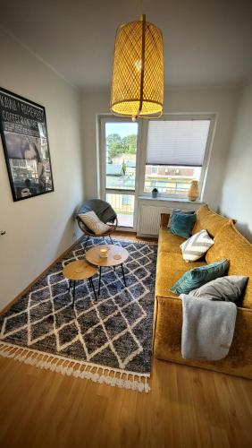a living room with a couch and a table at Apartament DANA piękna plaża wydmy las in Ustka