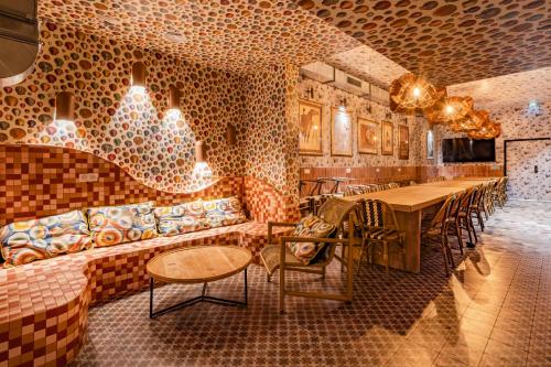 a restaurant with a brick wall and tables and chairs at Villa Saint Exupery Beach Hostel in Nice