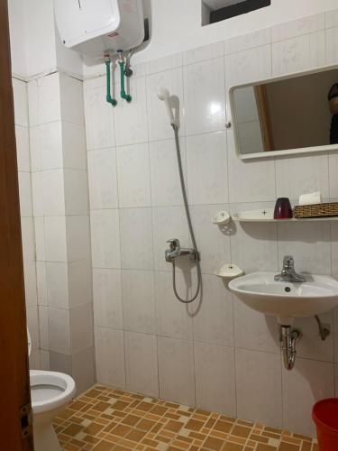 a bathroom with a shower and a sink at Thien Phuong Guesthouse in Sa Pa