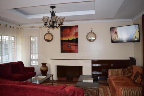 a living room with a couch and a fireplace at Sochati Casa Resort in Nairobi