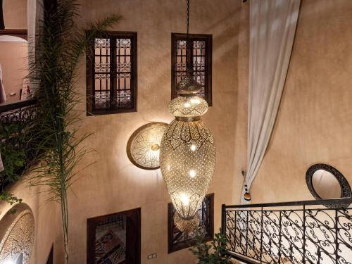 a large chandelier hanging from a wall at Riad Oumnia - Top emplacement - Riad en entier pour vous in Marrakesh