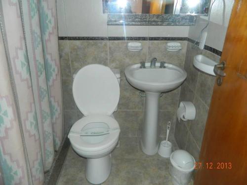 a bathroom with a toilet and a sink at Hotel Adriatico in Mar del Plata