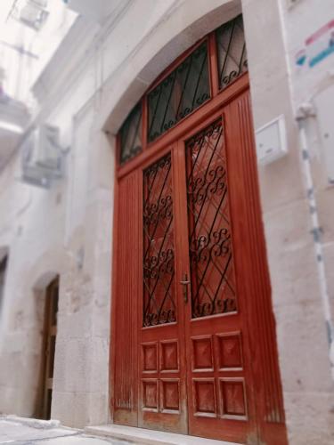 a wooden door on the side of a building at JASMINE HOUSE in Triggiano