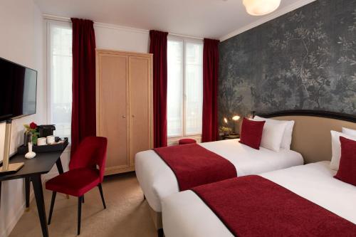 a hotel room with two beds and a desk and a television at Hotel Villa Romantic & Spa in Paris