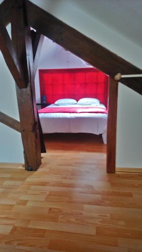 a bedroom with a bed with a red head board at 50 M OCÉAN maison classée 2 étoiles 2/7 personnes in Mimizan