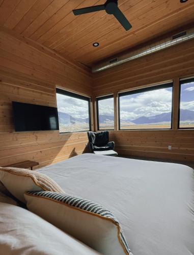 a bedroom with a large bed with a ceiling fan at Antelope Run - The Bunk House in Livingston