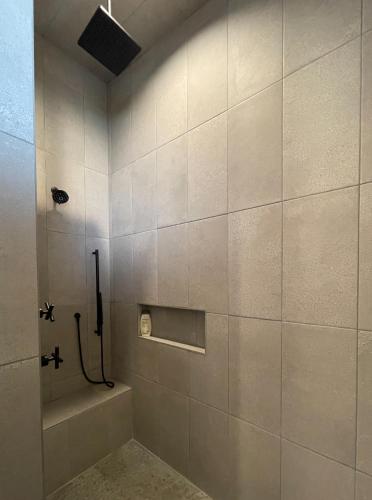 a tiled bathroom with a shower and a tub at Antelope Run - The Bunk House in Livingston