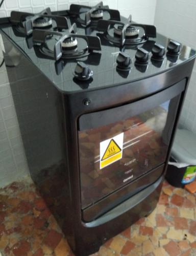a stove top oven with a sticker on it at Pousada Seu Jorge in Campinas
