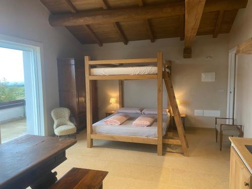 a bedroom with two bunk beds and a table at Rio Sabbioso in Dozza