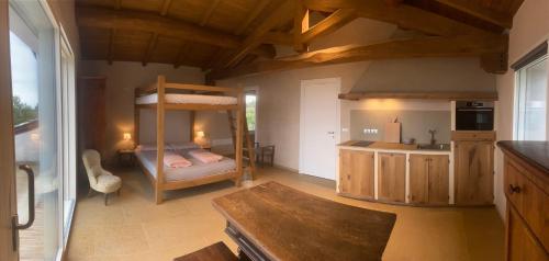 a room with a bunk bed and a kitchen at Rio Sabbioso in Dozza