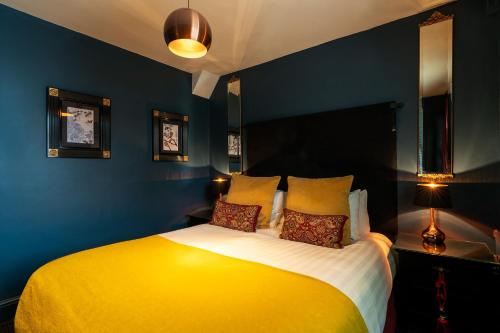 a bedroom with a large yellow bed with two pillows at Blanch House in Brighton & Hove