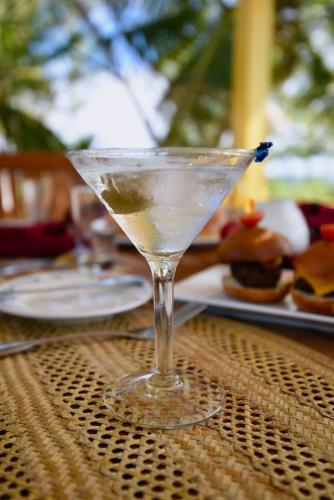 a martini glass sitting on top of a table at Stella Maris Resort Club in Stella Maris