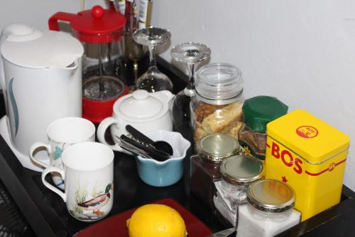 a counter with cups and other items on it at Newstead Farm - Country Cottages in Curryʼs Post