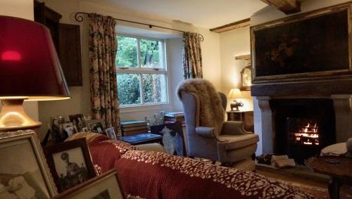 a living room with a couch and a fireplace at Orchard Cottage in Ripon