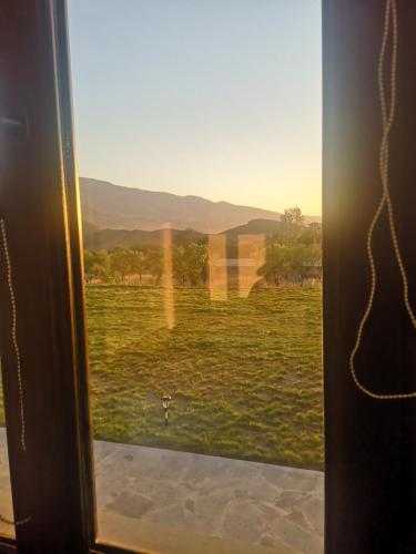a window with a view of a field of grass at 7ROOMS boutique hotel in Yeghegnadzor