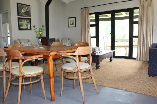 a living room with a wooden table and chairs at Newstead Farm - Country Cottages in Curryʼs Post