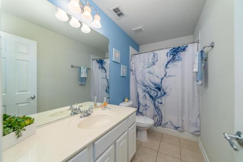a bathroom with a sink and a toilet and a shower at Windsor Hill Cheerful Villa w Pool 2miles to Dis in Orlando