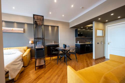 a bedroom with a bed and a dining room at Domus Aurelia in Rome