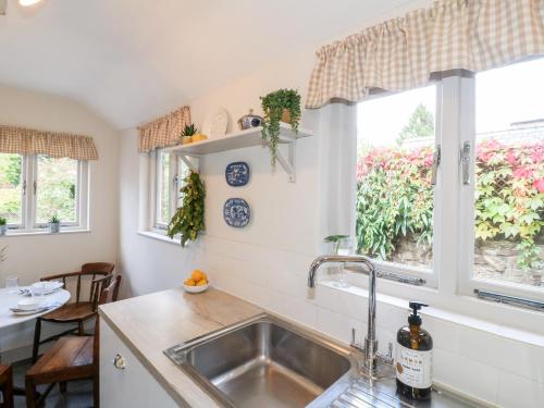 a kitchen with a sink and a window at 16 Long Row in Belper