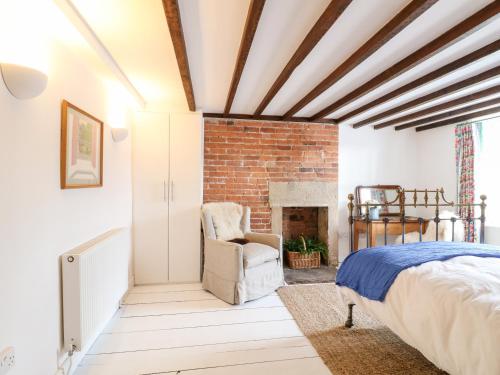 a bedroom with a bed and a fireplace at 16 Long Row in Belper