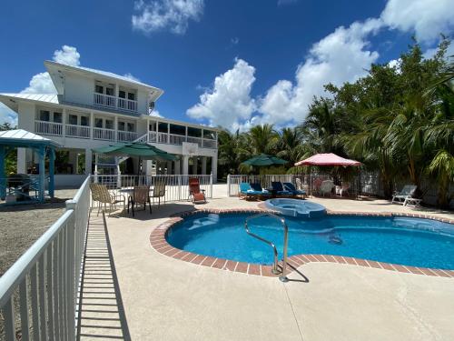 a swimming pool in front of a house at Luxury Oceanview Eco-friendly Villa Near Key West in Cudjoe Key