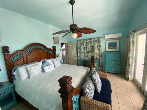 a bedroom with a bed and a ceiling fan at Luxury Oceanview Eco-friendly Villa Near Key West in Cudjoe Key