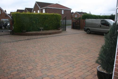 a driveway with a van parked next to a fence at Twin Bays in Hedon
