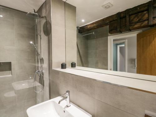 a bathroom with a sink and a mirror at Helton Fell in Kendal