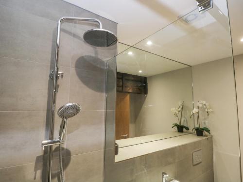 a shower with a glass door in a bathroom at Helton Fell in Kendal