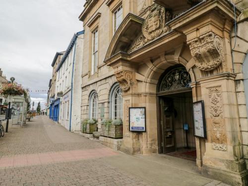 a building on a sidewalk next to a street at Helton Fell in Kendal