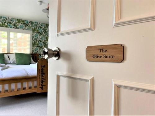 a door with a sign that reads the other suite at Ferryman`s Cottage at The Beetle & Wedge in Moulsford