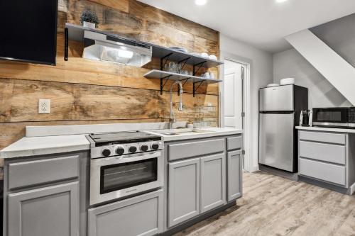 a kitchen with stainless steel appliances and a wooden wall at Whiskey on the River in Petal