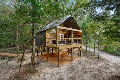 a tree house in the middle of a forest at Whiskey on the River in Petal
