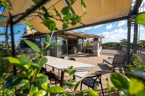 a patio with a white table and chairs at Domus Aurelia in Rome