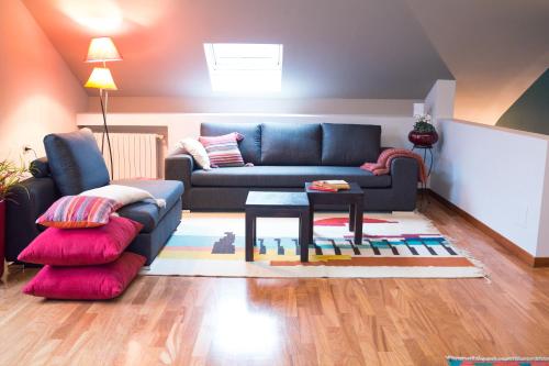 a living room with a blue couch and a table at Casa Agnese in Alba