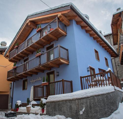 a blue building with wooden balconies on it at Rifugio Lilla in La Thuile