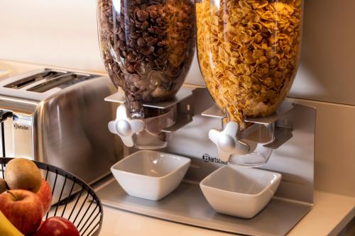 a counter with two vases and bowls on a microwave at Hôtel de France Gare de Lyon Bastille in Paris
