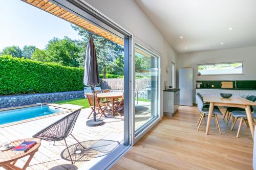un salon avec une terrasse et une piscine dans l'établissement Maison BOOA, à Sévrier