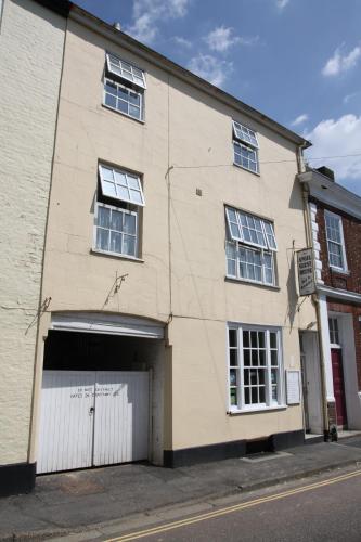 a large white building with a garage at Angel Guesthouse in Tiverton