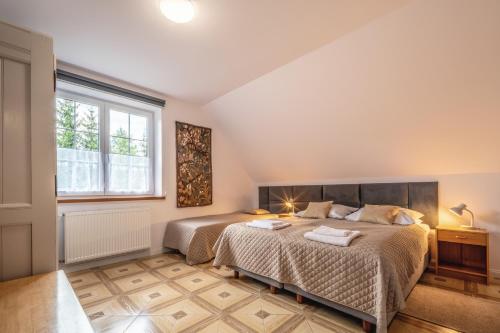 a bedroom with two beds and a window at Willa Pamiętnik in Stronie Śląskie