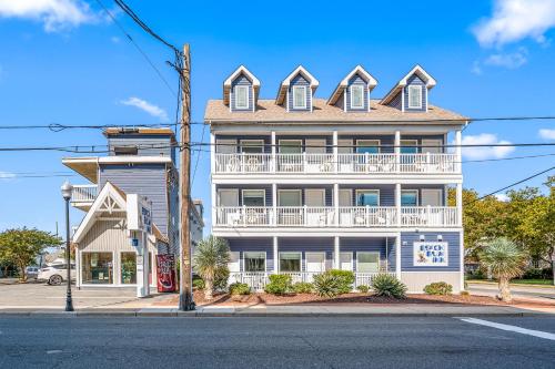 a large white building with a balcony on a street at Beach Bum Inn in Ocean City